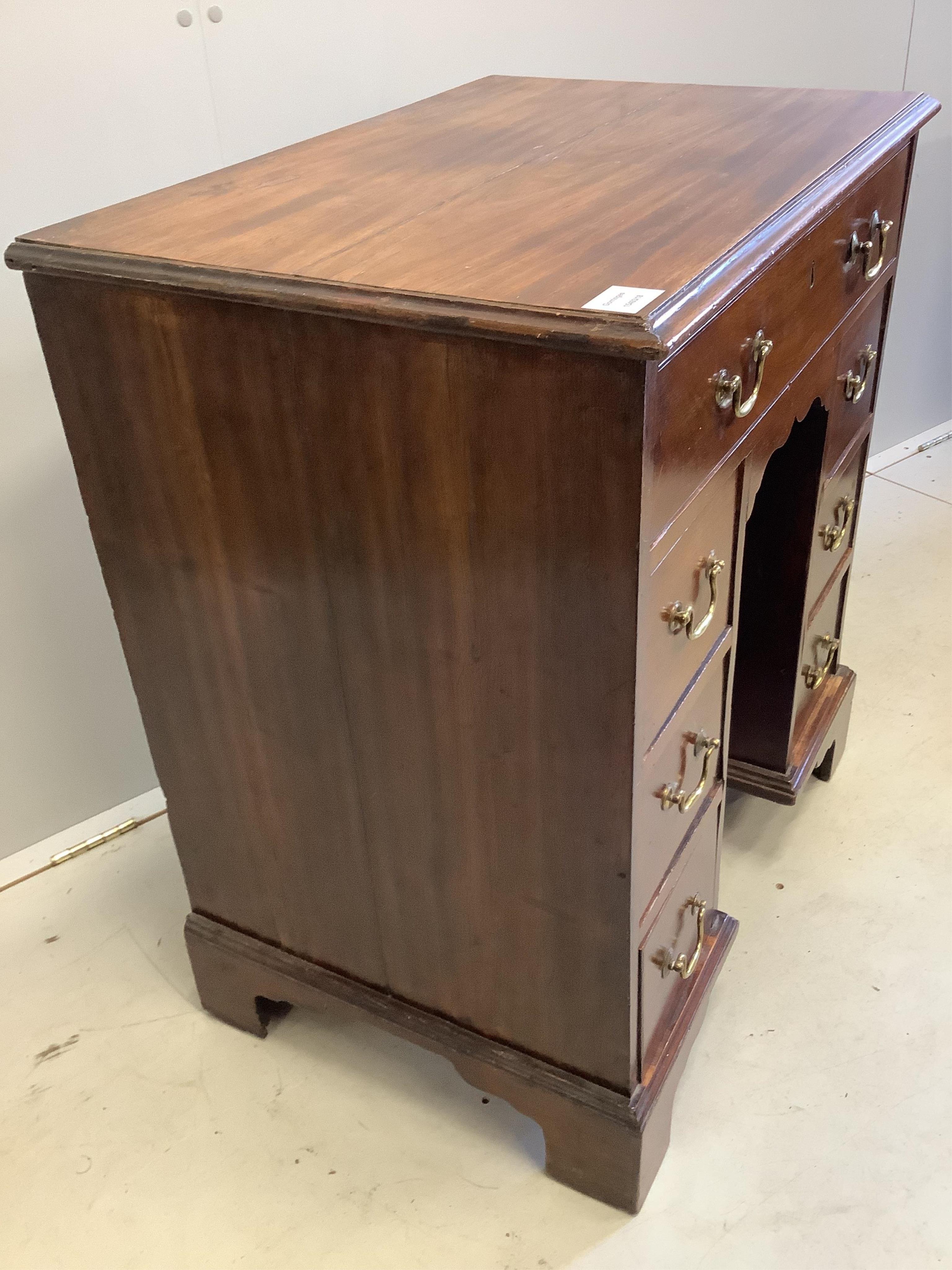 A George III mahogany kneehole desk, width 71cm, depth 48cm, height 80cm. Condition - fair to good